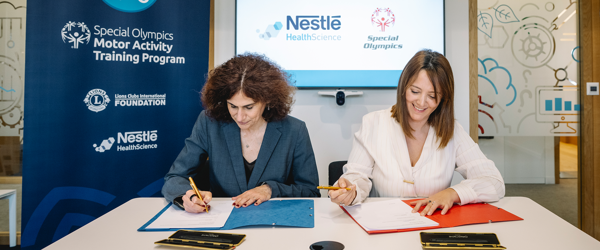 Two women sitting at the desk